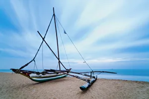 Outrigger fishing boat on Negombo Beach at sunrise, Sri Lanka, Asia Outrigger fishing boat on Negombo Beach at sunrise, Sri Lanka, Asia