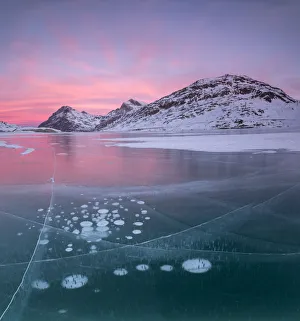 Panorama of ice bubbles and frozen surface of Lago Bianco at dawn, Bernina Pass Panorama of ice bubbles and frozen surface of Lago Bianco at dawn, Bernina Pass