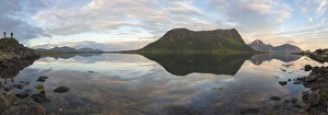 Panorama of pink clouds and peaks reflected in water at night time, Vengeren, Vagspollen Panorama of pink clouds and peaks reflected in water at night time, Vengeren, Vagspollen
