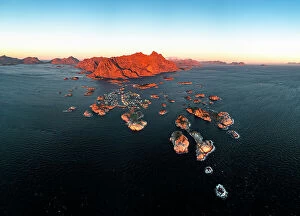 Norway Collection: Panoramic aerial view of the fishing village of Henningsvaer and mountains at sunset