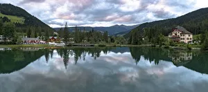 Panoramic of lake Dobbiaco at sunset in summer, Dobbiaco (Toblach), Dolomites Panoramic of lake Dobbiaco at sunset in summer, Dobbiaco (Toblach), Dolomites