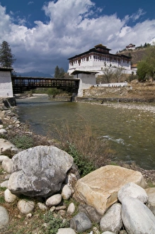 The Paro Tsong (a old castle) and a wooden covered bridge, Paro, Bhutan, Asia The Paro Tsong (a old castle) and a wooden covered bridge, Paro, Bhutan, Asia