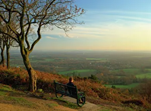 Person looking across the Weald with a view for 25 miles to the South Downs from the Greensand Ridge, Pitch Hill Person looking across the Weald with a view for 25 miles to the South Downs from the Greensand Ridge, Pitch Hill