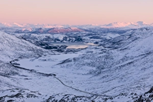 Pink sky at sunset on the snowy landscape and frozen sea surrounding Fjordbotn, Lysnes Pink sky at sunset on the snowy landscape and frozen sea surrounding Fjordbotn, Lysnes