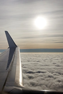 Europe Cloudy Skies Prints: Plane wing with low lying clouds and sunburst, United Kingdom, Europe