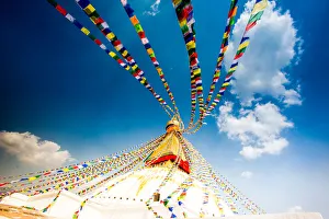 Prayer flags and Buddhist stupa at Bouddha (Boudhanath), UNESCO World Heritage Site Prayer flags and Buddhist stupa at Bouddha (Boudhanath), UNESCO World Heritage Site