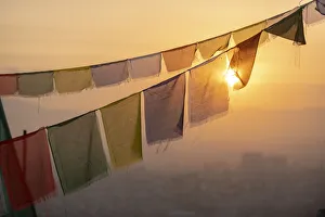 Prayer flags at Swayambhunath (Monkey Temple) in front of the city at sunrise, Kathmandu Prayer flags at Swayambhunath (Monkey Temple) in front of the city at sunrise, Kathmandu