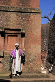 Priest holding cross swings an incense burner at the rock-hewn monolithic church of Bet Giyorgis Priest holding cross swings an incense burner at the rock-hewn monolithic church of Bet Giyorgis