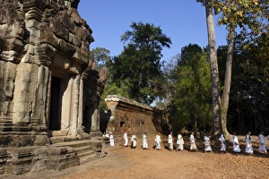 A procession of Buddhist nuns file through the temples of Angkor, UNESCO World Heritage Site A procession of Buddhist nuns file through the temples of Angkor, UNESCO World Heritage Site