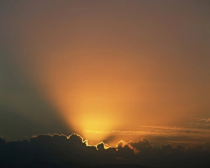 Outdoor Travel Images Prints: Rays of light bursting out of dark clouds