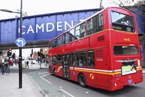 A red double decker bus drives towards the Camden Town area of London, England A red double decker bus drives towards the Camden Town area of London, England