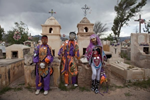 Revellers in costumes and masks at a cemetery in Humahuaca during carnival in Jujuy Revellers in costumes and masks at a cemetery in Humahuaca during carnival in Jujuy