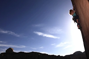 A rock climber tackles an overhanging wall on the cliffs of Indian Creek A rock climber tackles an overhanging wall on the cliffs of Indian Creek