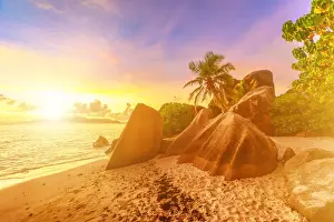 African Island Getaways Prints: Rocks on beach and palm trees, Anse Source d Argent at sunset, La Digue, Seychelles