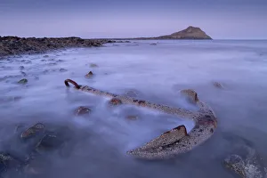 Rusted anchor from a shipwreck near Worms Head on the Gower, Wales, United Kingdom Rusted anchor from a shipwreck near Worms Head on the Gower, Wales, United Kingdom