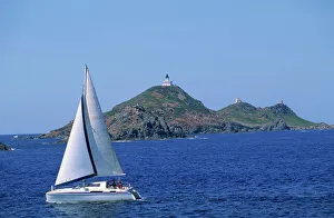 Sailing boat with the Semaphore Lighthouse behind, Iles Sanguinaires, island of Corsica Sailing boat with the Semaphore Lighthouse behind, Iles Sanguinaires, island of Corsica