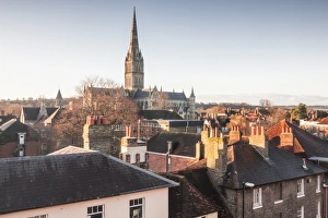 Salisbury Cathedral Prints: Salisbury cathedral across the rooftops of the city, Salisbury, Wiltshire, England
