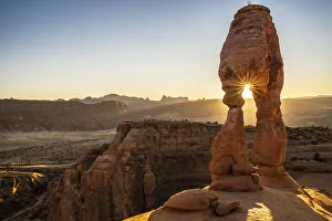 Arches National Park Photos Prints: Setting sun through Delicate Arch with sunburst, Arches National Park, Utah