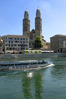 Sightseeing boat on the River Limmat in front of Grossmunster church Sightseeing boat on the River Limmat in front of Grossmunster church