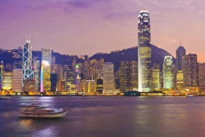 The skyscrapers of Hong Kong Island illuminated at sunset across Victoria Harbour The skyscrapers of Hong Kong Island illuminated at sunset across Victoria Harbour