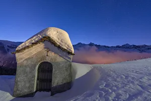 Small chapel covered with snow in the starry winter night, Andossi, Madesimo Small chapel covered with snow in the starry winter night, Andossi, Madesimo