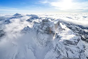 Veneto Region Italy Tourism Prints: Snow capped Monte Pelmo emerging from clouds, aerial view, Dolomites, Belluno province
