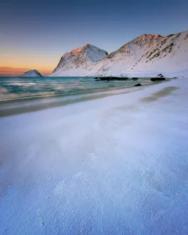 Snow covered Haukland Beach at sunset, Lofoten Islands, Nordland, Norway, Europe Snow covered Haukland Beach at sunset, Lofoten Islands, Nordland, Norway, Europe