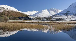Snowclad sunlit fells around Hartstop reflected in Brothers Water, Lake District Snowclad sunlit fells around Hartstop reflected in Brothers Water, Lake District