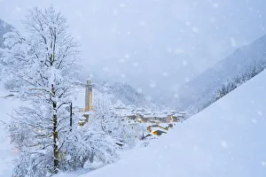 Snowflakes falling on mountain huts in the fairy tale alpine village at Christmas time Snowflakes falling on mountain huts in the fairy tale alpine village at Christmas time
