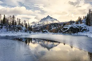 Snowy peak of Sasso Moro reflected in the frozen lake MufulA¨, Malenco Valley Snowy peak of Sasso Moro reflected in the frozen lake MufulA¨, Malenco Valley