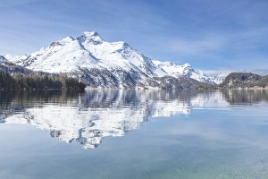 Snowy peaks reflected in the clear water of Lake Sils, Maloja, Canton of Graubunden Snowy peaks reflected in the clear water of Lake Sils, Maloja, Canton of Graubunden