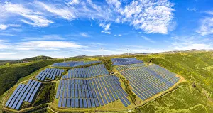 Solar panels and wind turbines on the green plateau, Encumeada, Madeira island, Portugal Solar panels and wind turbines on the green plateau, Encumeada, Madeira island, Portugal
