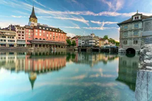 St. Peter church and old buildings of Lindenhof mirrored in Limmat River at dawn, Zurich St. Peter church and old buildings of Lindenhof mirrored in Limmat River at dawn, Zurich
