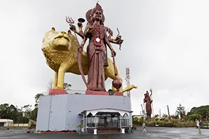 Statue of the Hindu goddess Durga, 108 feet tall, with her lion vehicle Manastala, at Ganga Talao, Mauritius Statue of the Hindu goddess Durga, 108 feet tall, with her lion vehicle Manastala, at Ganga Talao, Mauritius