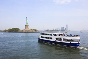 The Statue of Liberty and ferry, Liberty Island, New York City, New York The Statue of Liberty and ferry, Liberty Island, New York City, New York