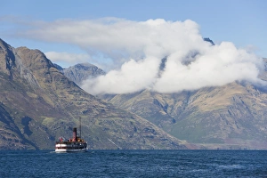 The steamship TSS Earnslaw on Lake Wakatipu, clouds over Walter Peak, Queenstown The steamship TSS Earnslaw on Lake Wakatipu, clouds over Walter Peak, Queenstown