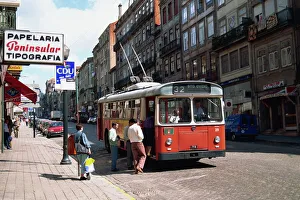 Street scene of people getting on a trolley bus in Street scene of people getting on a trolley bus in