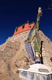 A stupa bound with prayer flags stands under the walls of Leh Palace, Leh A stupa bound with prayer flags stands under the walls of Leh Palace, Leh