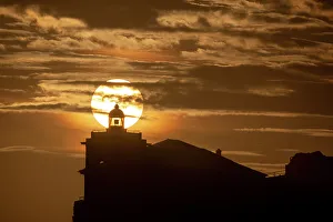European Coastal Scenery Images Prints: Sun aligned with the silhouette of the lighthouse of Luarca, Asturias, Spain, Europe