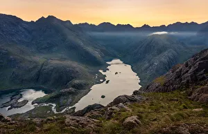 The sun setting behind the Black Cuillin Ridge with the remote Loch Coruisk in the glen The sun setting behind the Black Cuillin Ridge with the remote Loch Coruisk in the glen