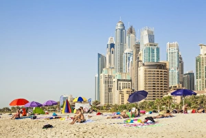 Sunbathers on the Public Dubai Beach at JBR (Jumeirah Beach Resort), Dubai, United Arab Emirates Sunbathers on the Public Dubai Beach at JBR (Jumeirah Beach Resort), Dubai, United Arab Emirates
