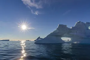Sunburst on iceberg in De Dodes Fjord (Fjord of the Dead), Baffin Bay, Greenland Sunburst on iceberg in De Dodes Fjord (Fjord of the Dead), Baffin Bay, Greenland