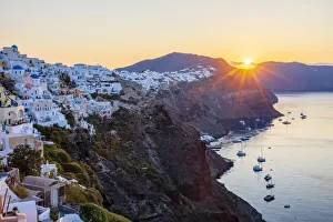 Sunrise over coast of Oia and typical white buildings, Santorini, Cyclades, Greek Islands, Greece, Europe Sunrise over coast of Oia and typical white buildings, Santorini, Cyclades, Greek Islands, Greece, Europe