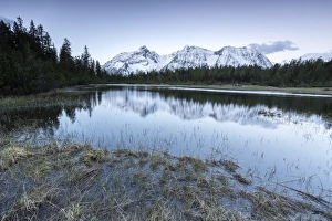 Sunrise frames the snowy peaks reflected in Lake Entova, Malenco Valley, Province of Sondrio Sunrise frames the snowy peaks reflected in Lake Entova, Malenco Valley, Province of Sondrio