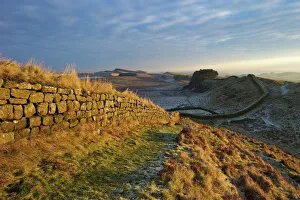 Sunrise and Hadrians Wall National Trail in winter, looking to Housesteads Fort, Hadrians Wall Sunrise and Hadrians Wall National Trail in winter, looking to Housesteads Fort, Hadrians Wall
