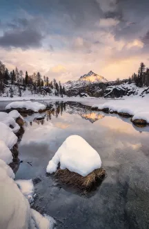 Sunrise above snowy peak of Sasso Moro mirrored in lake MufulA¨, Malenco Valley Sunrise above snowy peak of Sasso Moro mirrored in lake MufulA¨, Malenco Valley