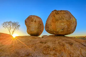 Australian Desert Scenery Prints: Sunset light rays at Devils Marbles, the Eggs of mythical Rainbow Serpent, at Karlu Karlu