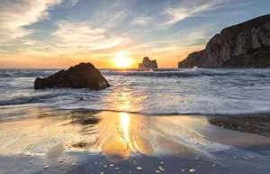 The sunset is reflected on the Beach of Masua, Iglesias, Sud Sardegna province, Sardinia The sunset is reflected on the Beach of Masua, Iglesias, Sud Sardegna province, Sardinia