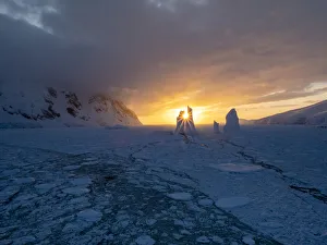 Sunset over an unusual iceberg near Petermann Island, Antarctica, Polar Regions Sunset over an unusual iceberg near Petermann Island, Antarctica, Polar Regions