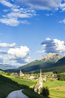 Sunshine over green pastures and village of Villabassa (Niederdorf) in summer Sunshine over green pastures and village of Villabassa (Niederdorf) in summer
